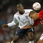 England footballer Emile Heskey (L) challenges Russian footballer Alexey Berezutskiy during a Europe qualifying match
